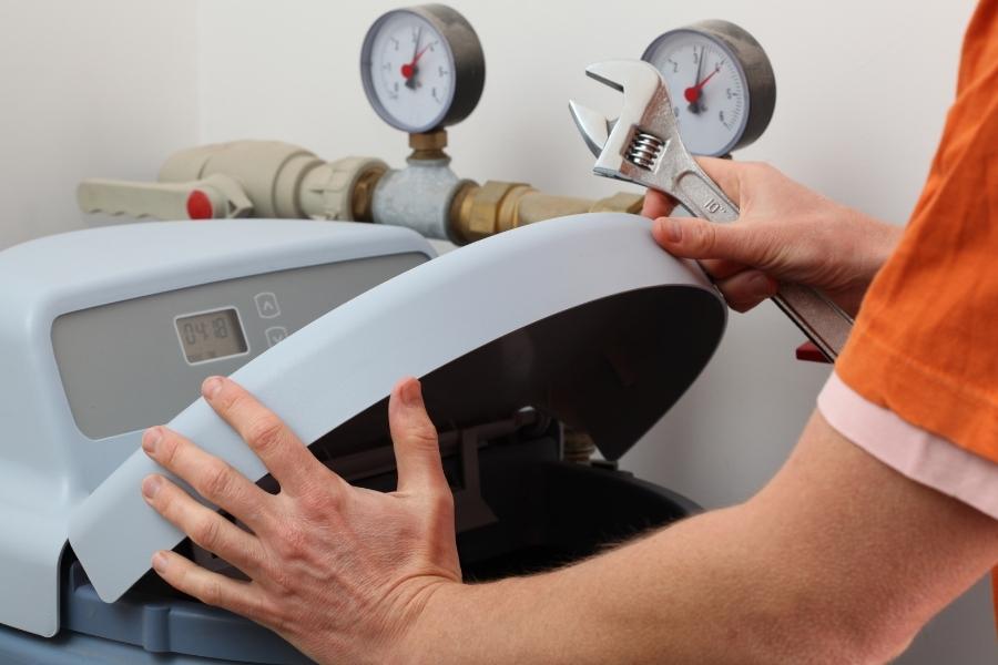 technician close up installing water softener system albuquerque nm