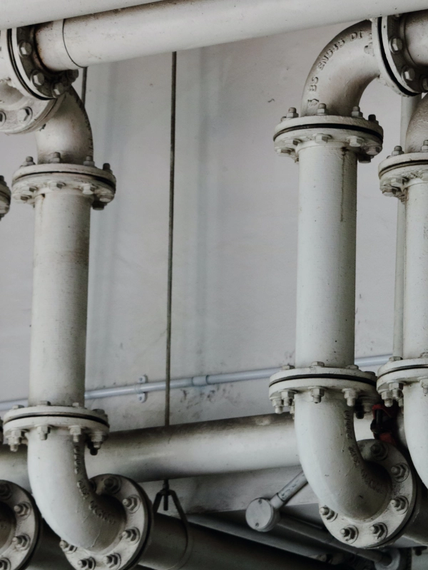 black and white pbc pipes of a plumbing area of a building